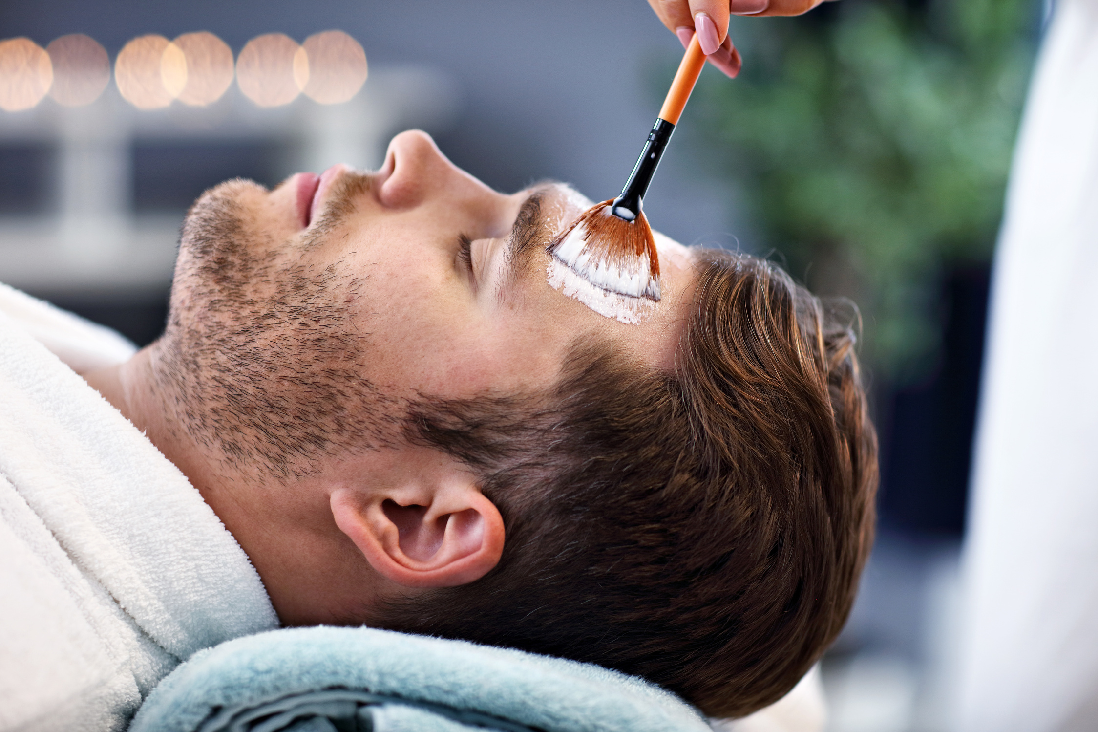 Handsome Man Having Facial in Spa Salon