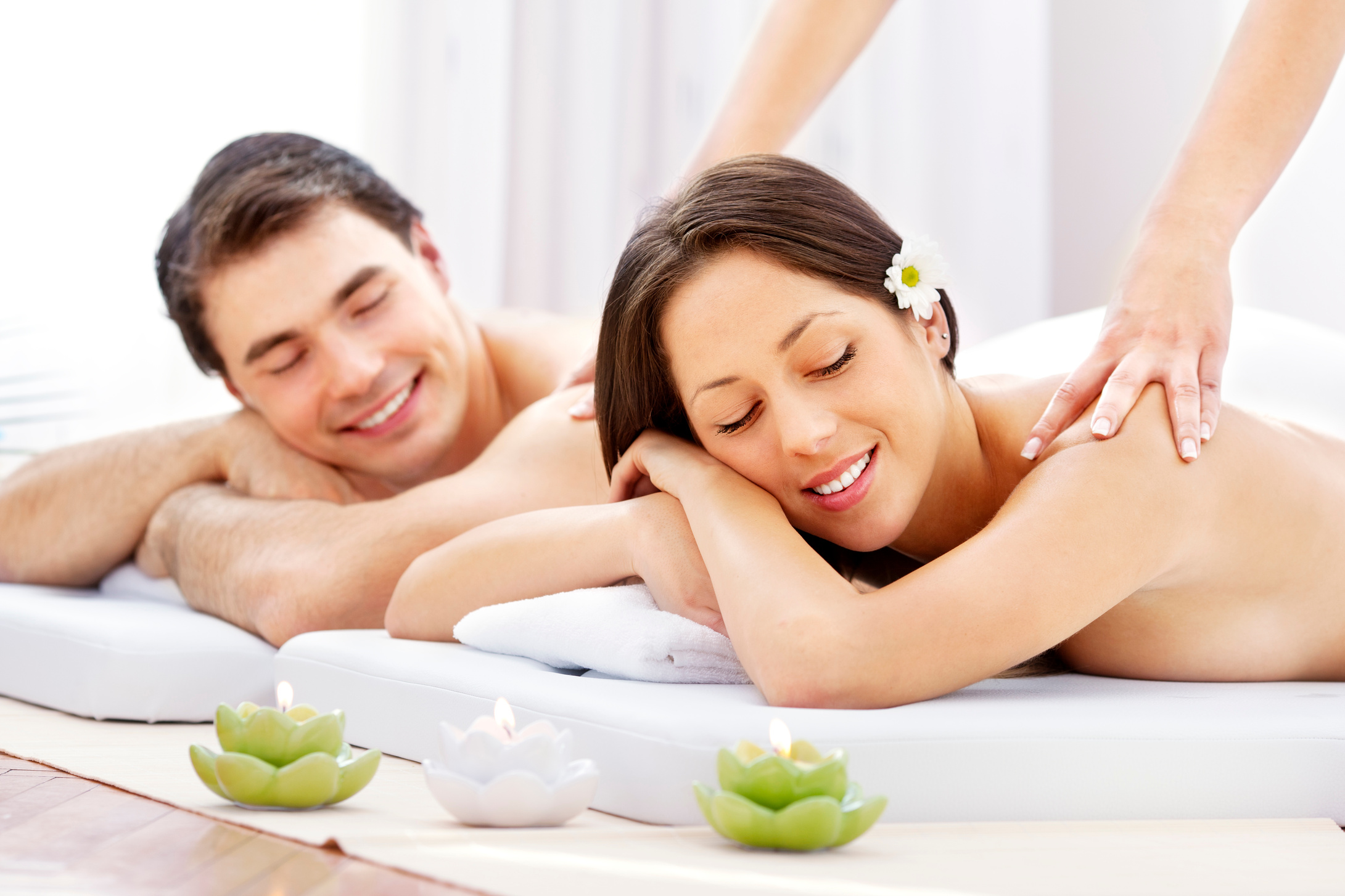 Couple Having Massage At Spa Center